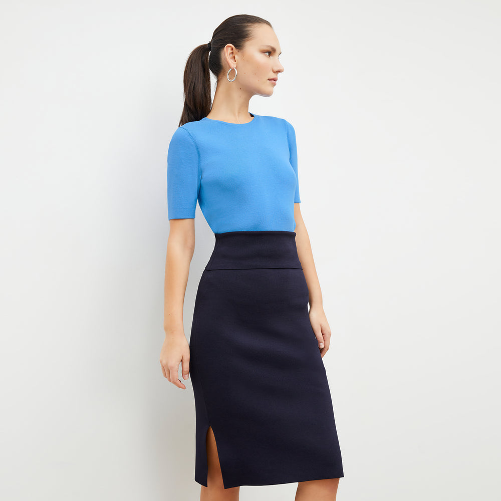 Front image of a woman wearing the harlem skirt in navy