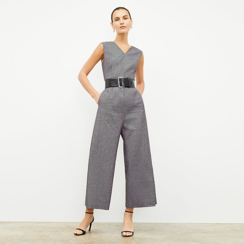 front image of a woman wearing the demi jumpsuit in gingham linen