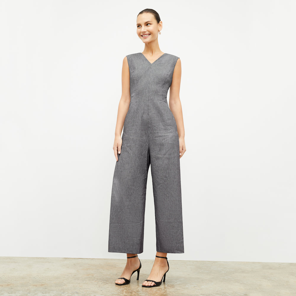 front image of a woman wearing the demi jumpsuit in gingham linen