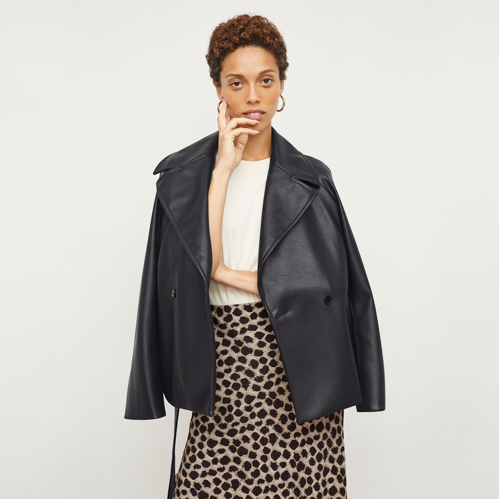Front image of a woman standing wearing the Alphonso Jacket—Vegan Leather in Black
