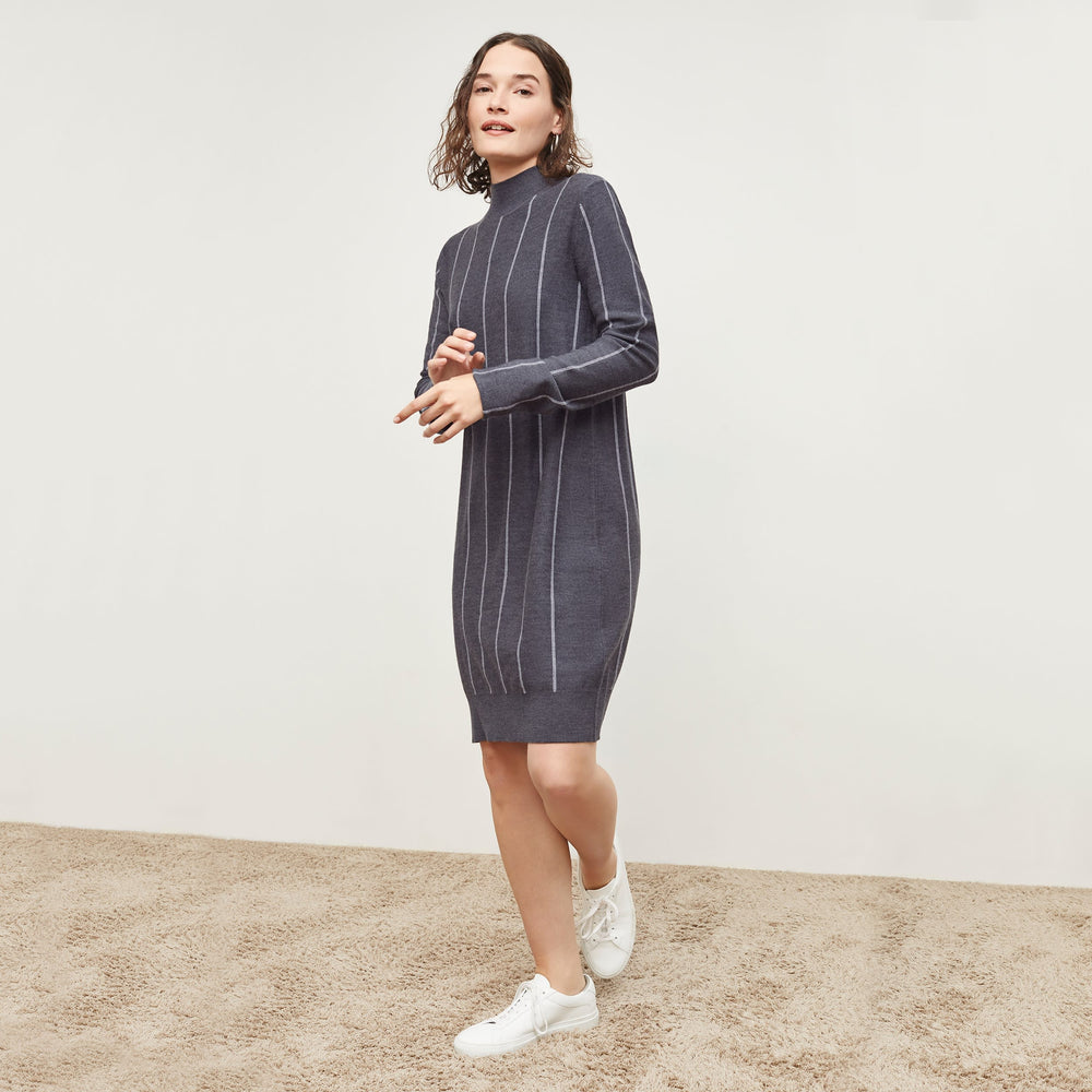 Side image of a woman standing wearing the Effy DressāBraided Stripe in Charcoal / Ivory