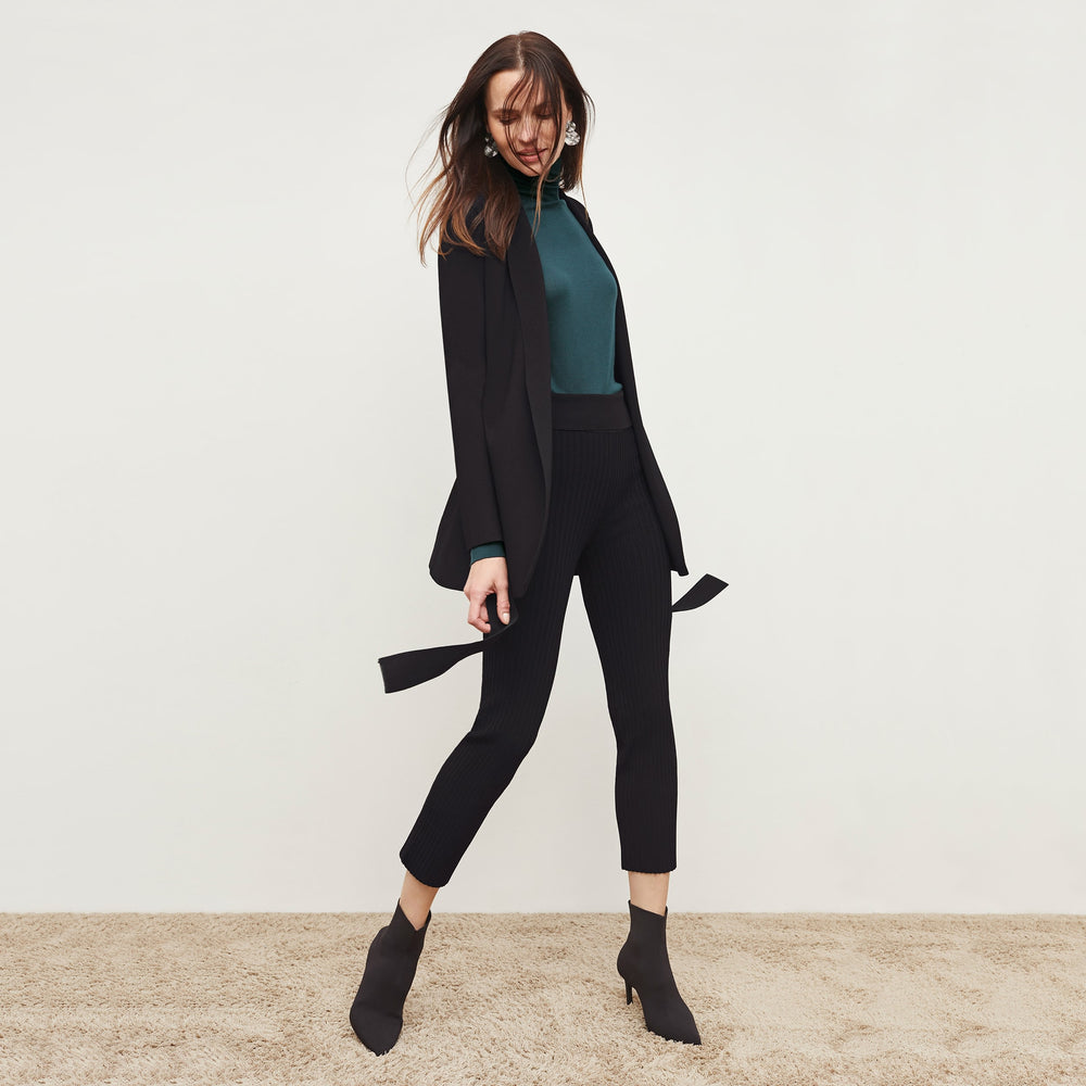Front image of a woman standing wearing the Finley Legging—Ribbed Jardigan Knit in Black