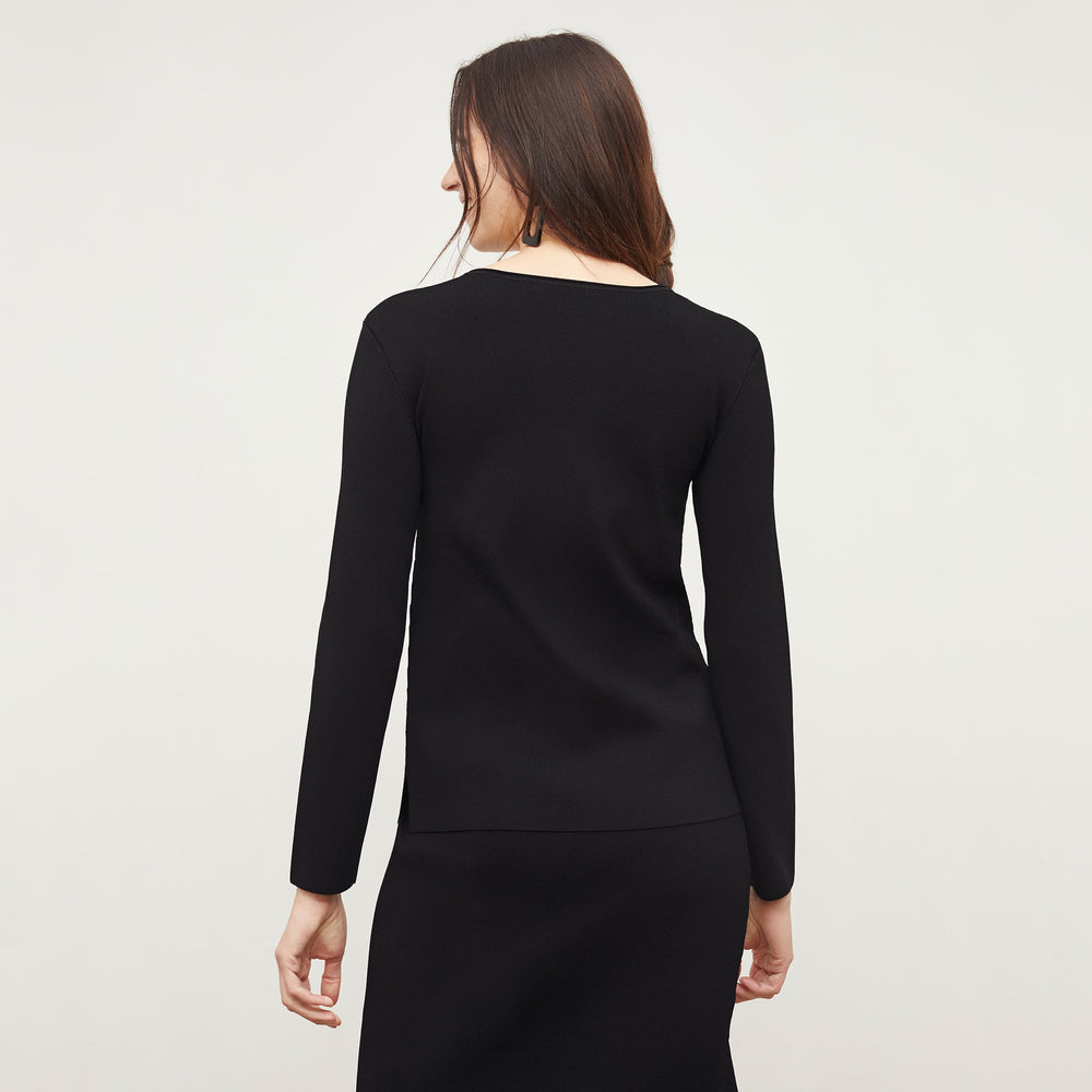 Back image of a woman standing wearing the Malin TopāJardigan Knit in Black