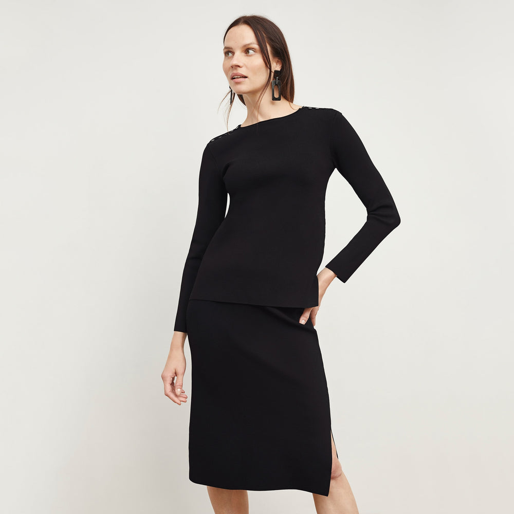 Front image of a woman standing wearing the Malin TopāJardigan Knit in Black