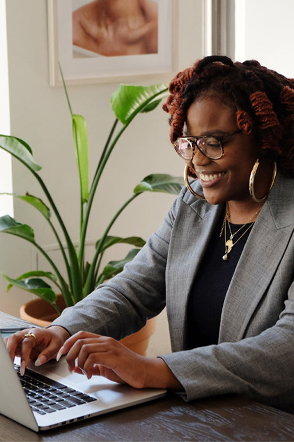 woman sitting at a desk on her computer