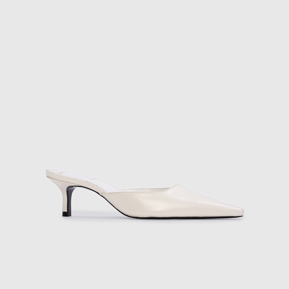 White high-heeled shoe on a light gray background
