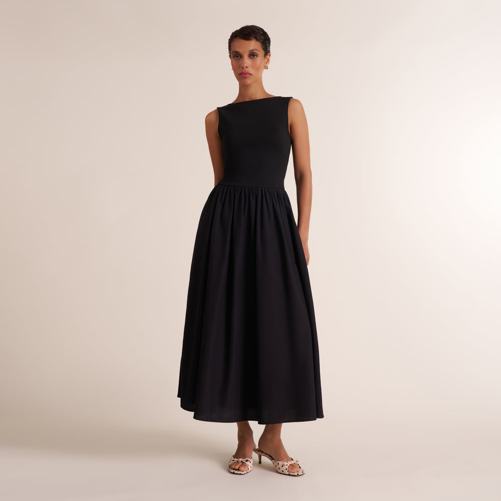 Woman wearing a sleeveless black maxi dress