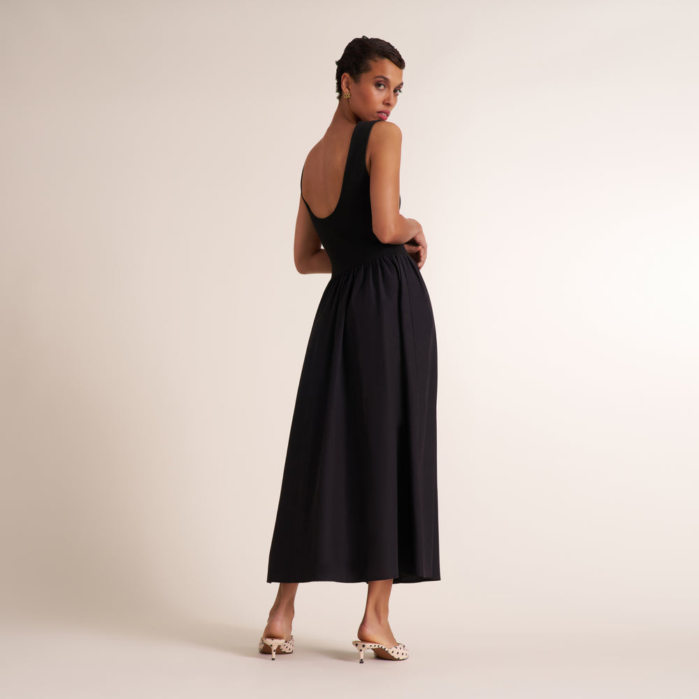 Woman wearing a sleeveless black maxi dress
