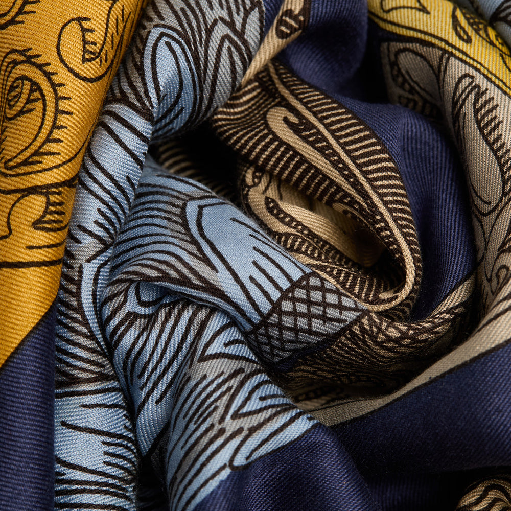 Close-up of patterned fabric with blue, yellow, and brown colors.