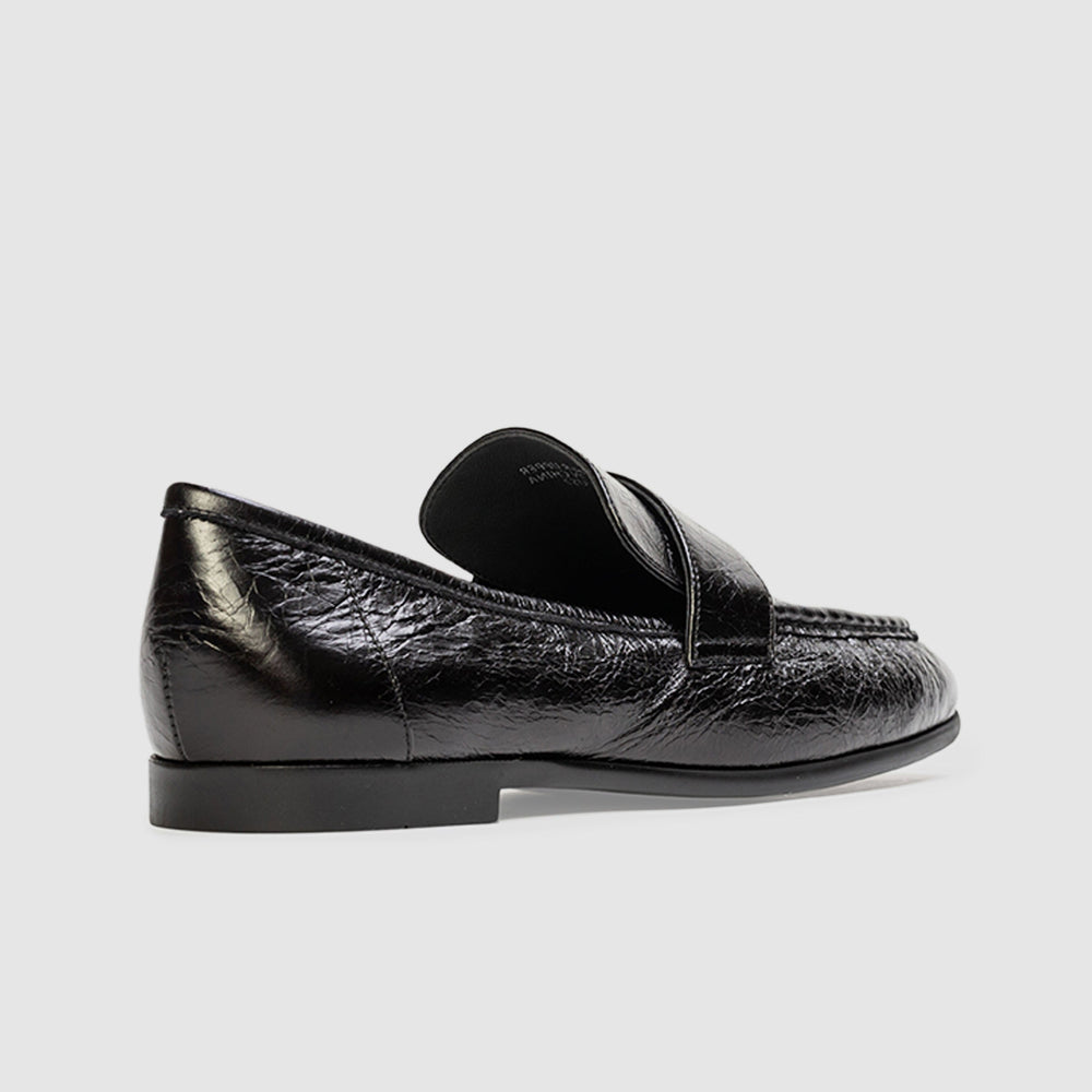 back of a black loafer