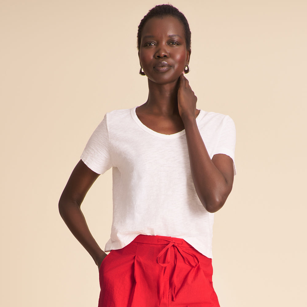 front image of a woman wearing the kenya shirt in white