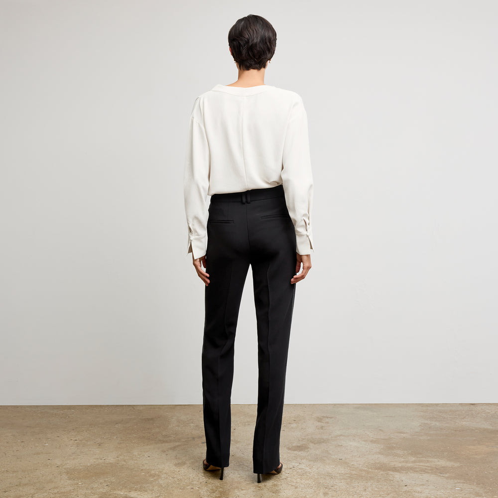 back image of a woman wearing the annmarie top in ivory