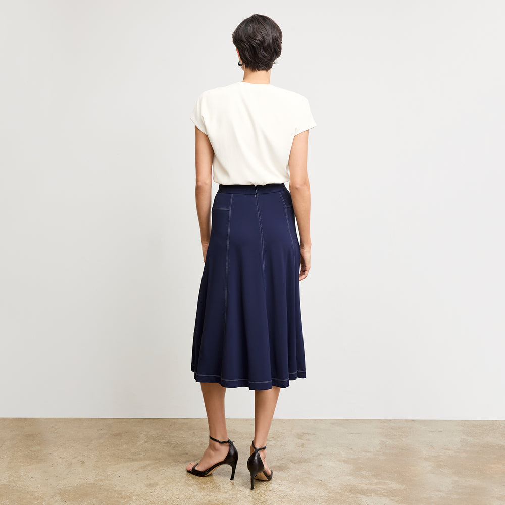 back image of a woman wearing the shannon skirt in soft navy