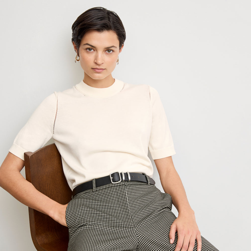 front image of a woman wearing the becca top in ivory