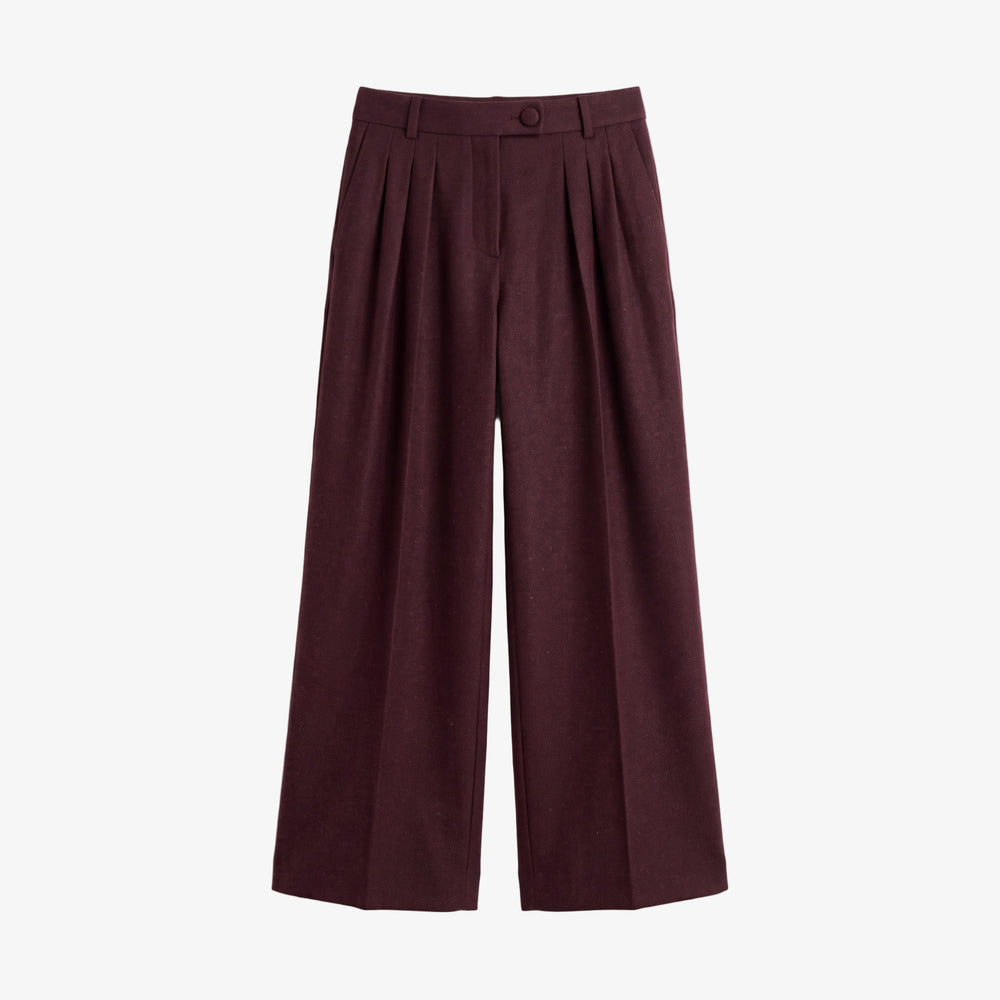 A pair of high-waisted, wide-leg cropped trousers in a deep burgundy color, featuring pleated detailing at the front and a single button closure at the waistband, shown against a plain light gray background.