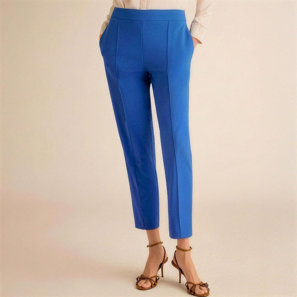 Blue pants worn by a person on a beige background