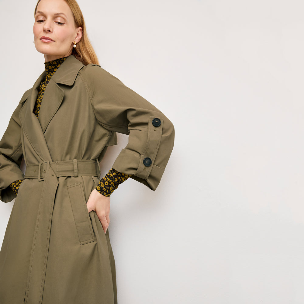 front image of a woman wearing the curtis trench in bancha green