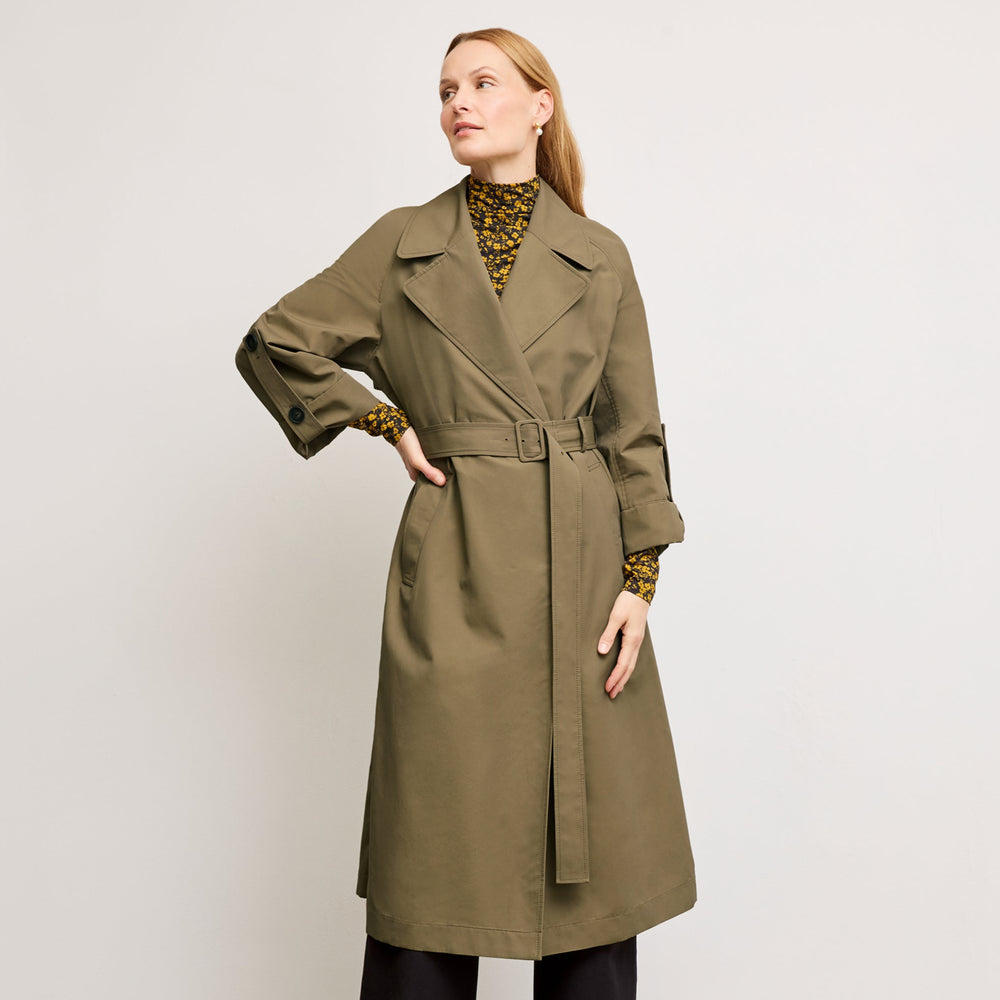 front image of a woman wearing the curtis trench in bancha green