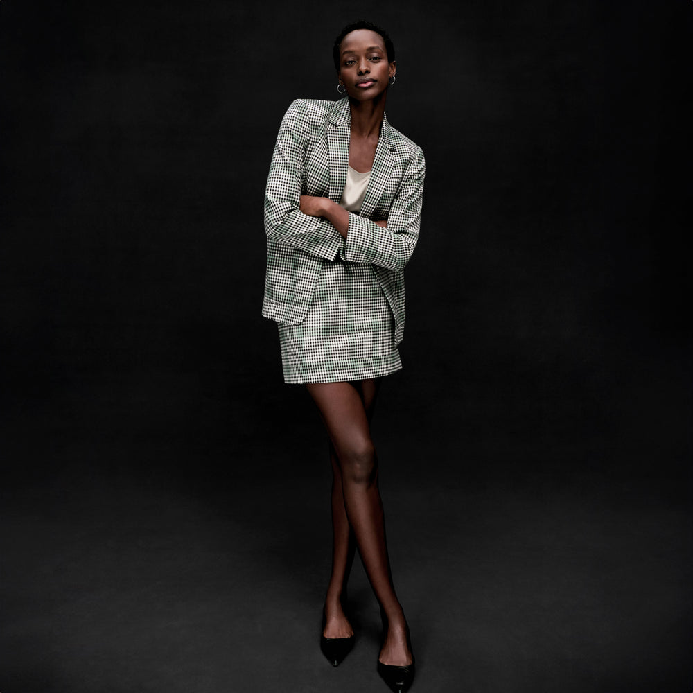 front image of a woman wearing the dolly jacket in check plaid