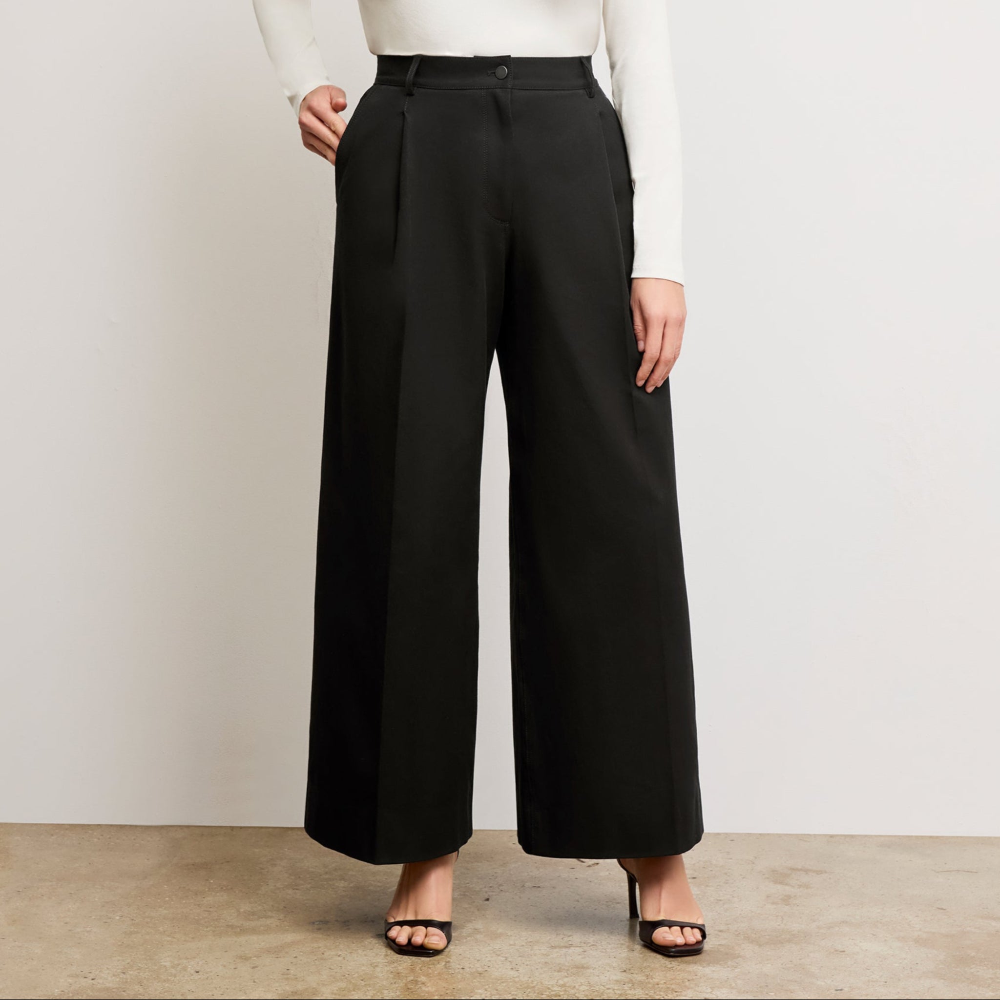 Front image of a woman wearing the Harrison Pant in Black 