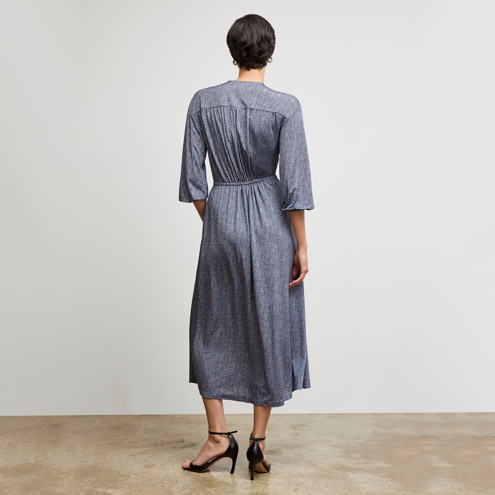 Back image of a woman wearing the hope dress in blueprint sketch