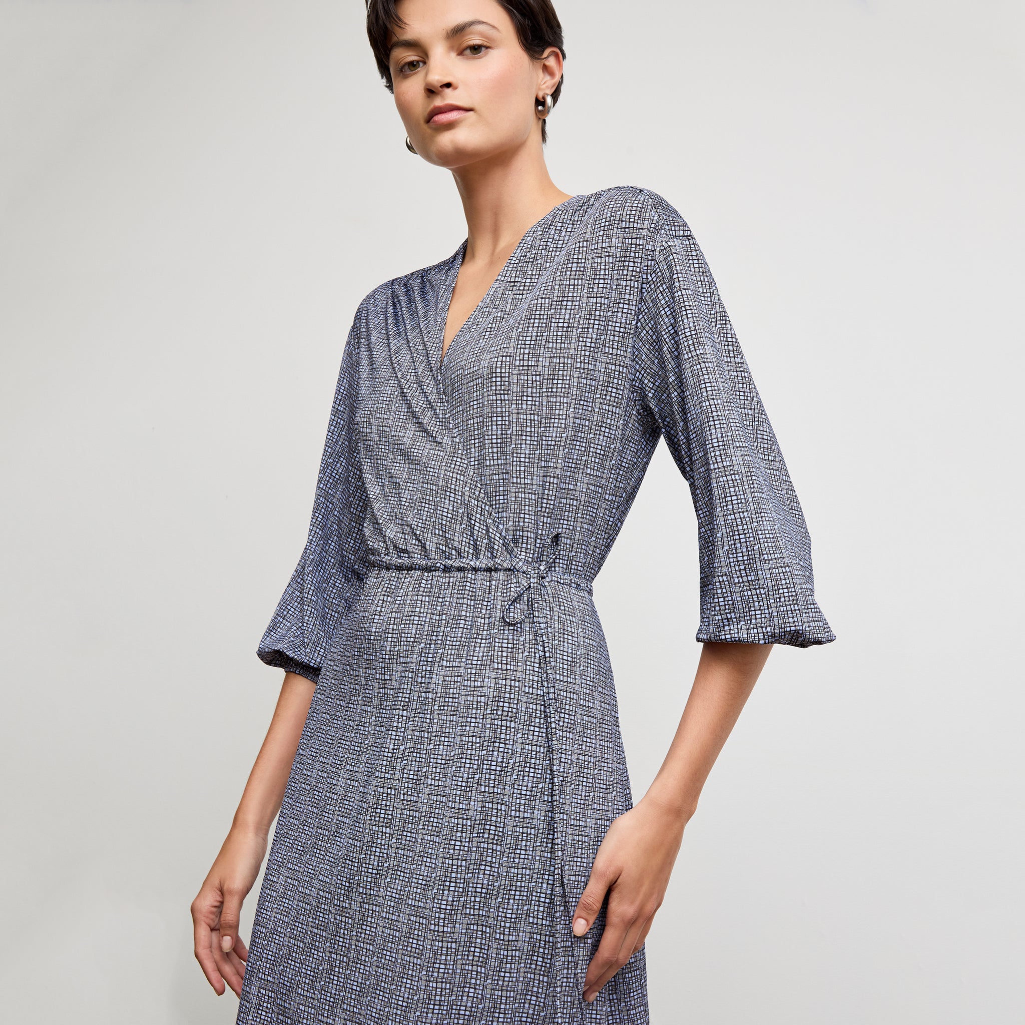 Front image of a woman wearing the hope dress in blueprint sketch