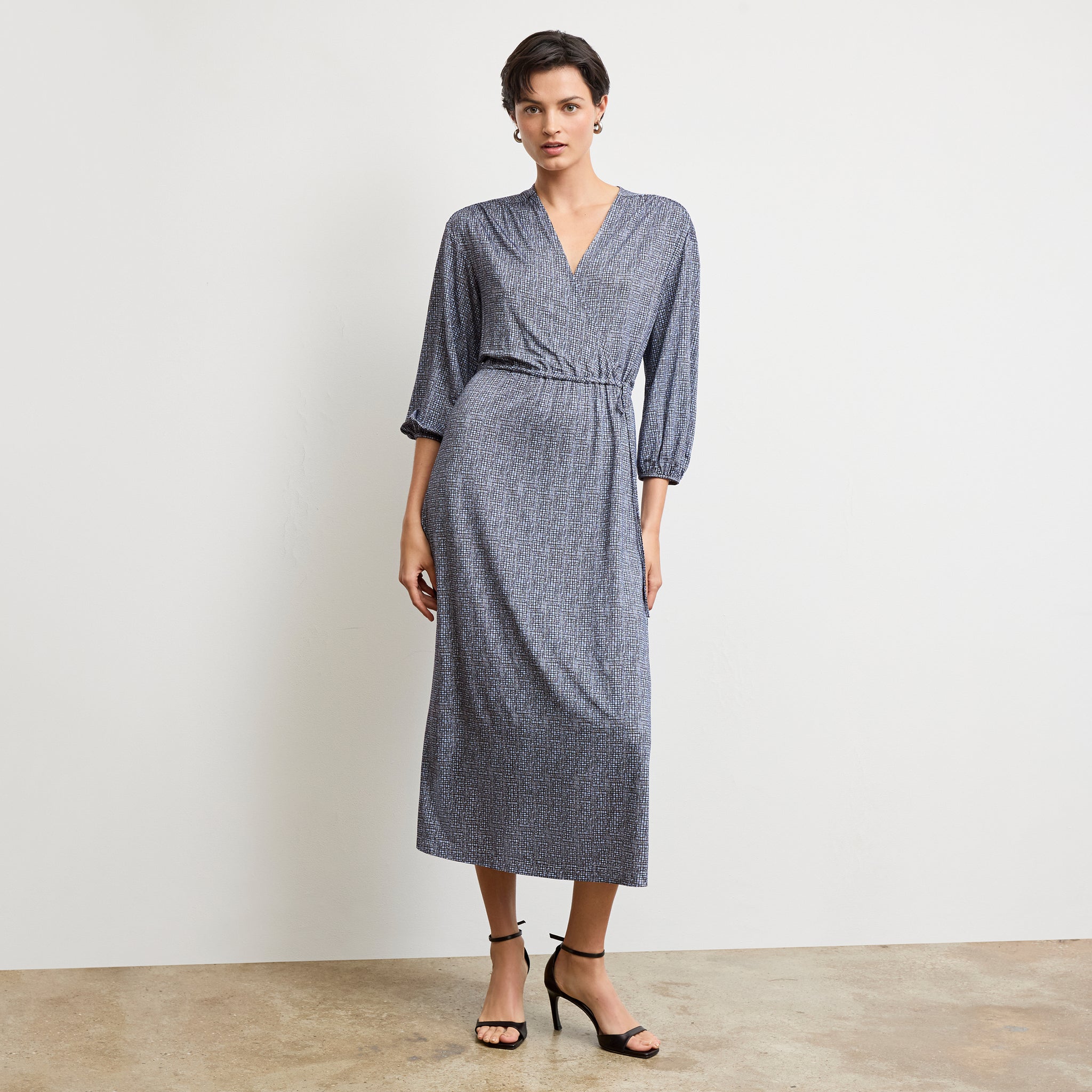 Front image of a woman wearing the hope dress in blueprint sketch