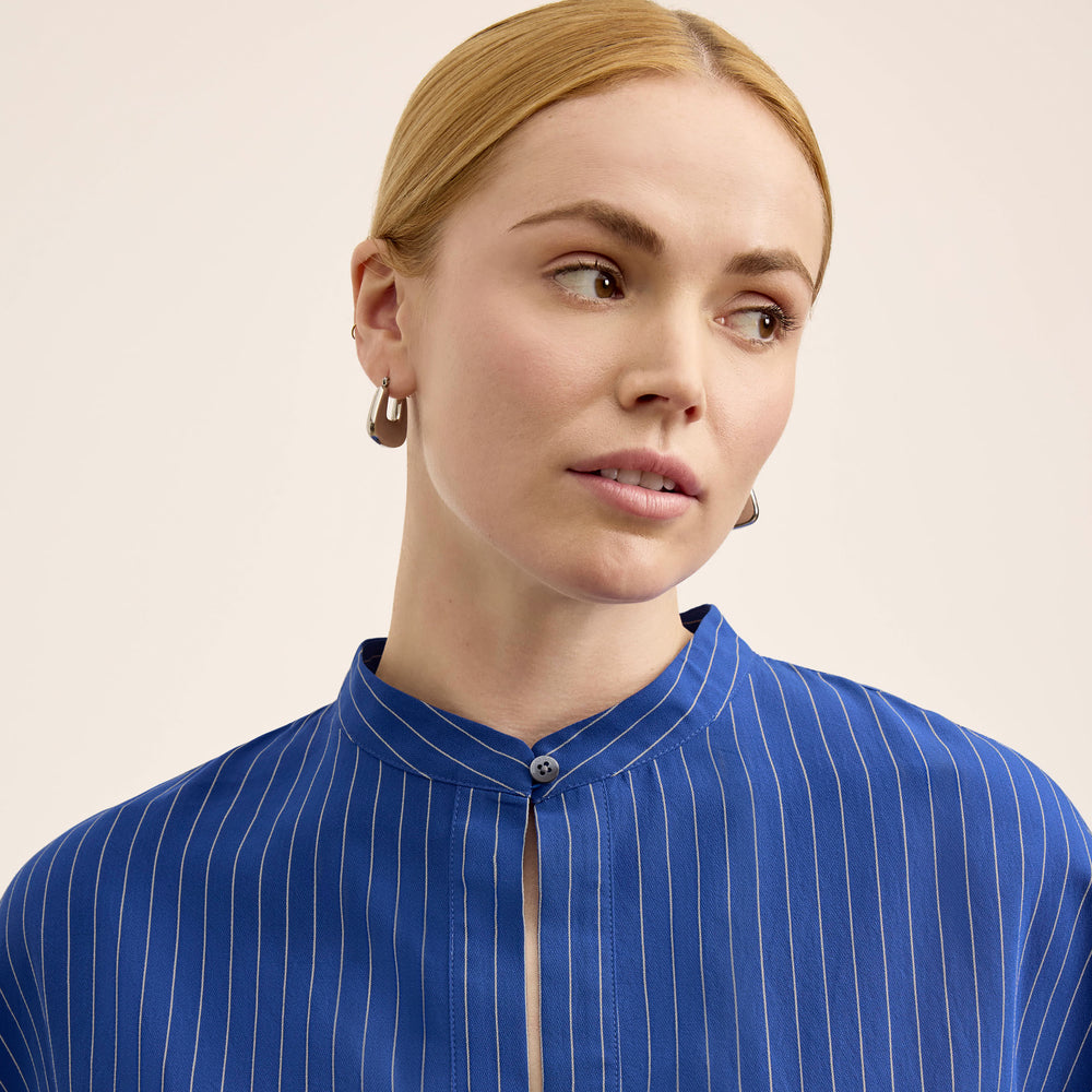 front image of a woman wearing the kylan top in soft stripe