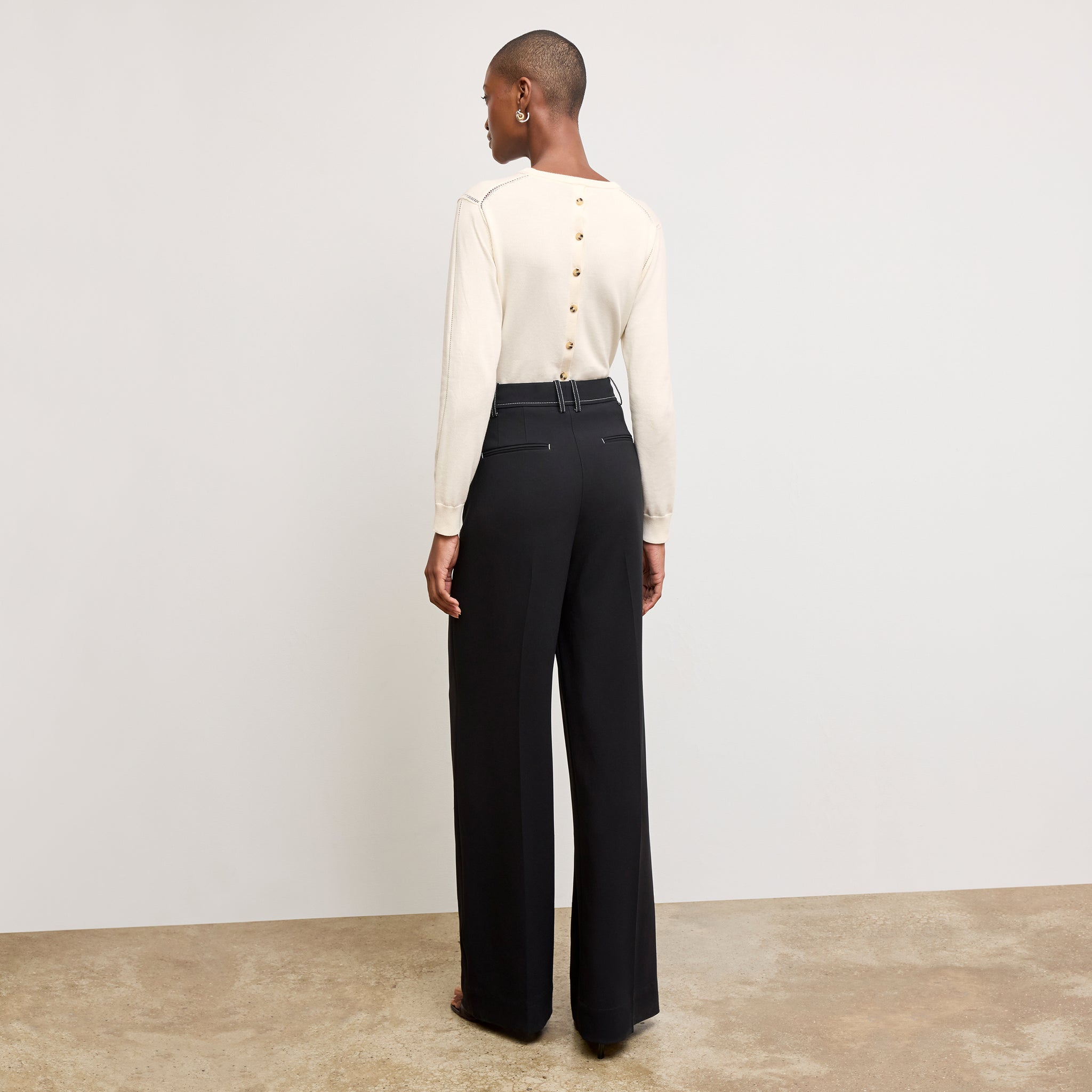 back image of a woman wearing the larissa sweater in ivory