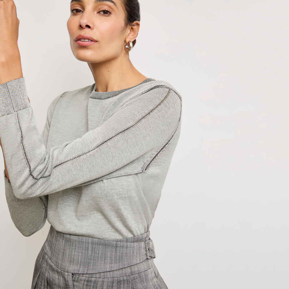 Front image of a woman wearing the larissa sweat in light gray/ivory