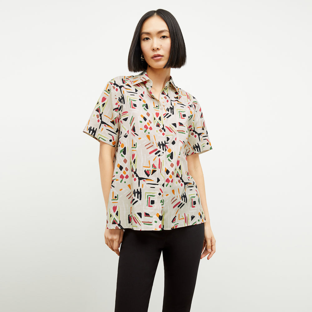 front image of a woman wearing the livingston top in rhythm print