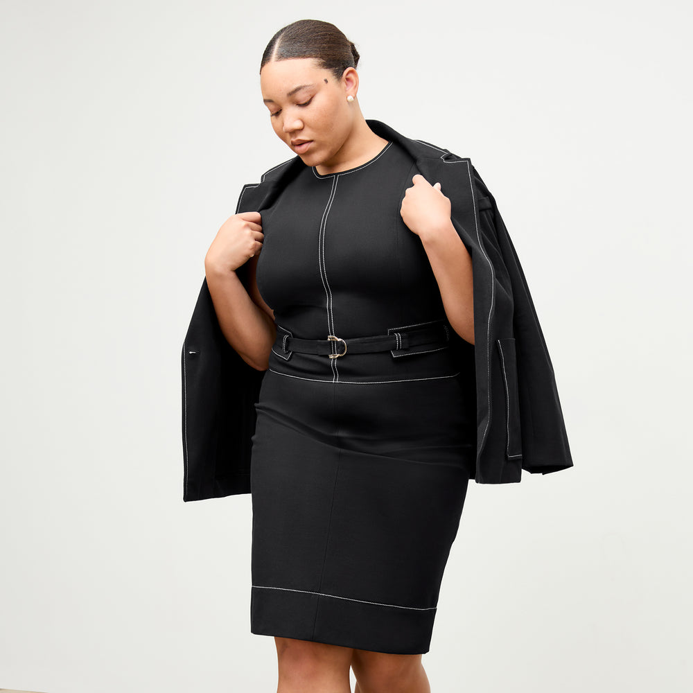 front image of a woman wearing the maude dress in black