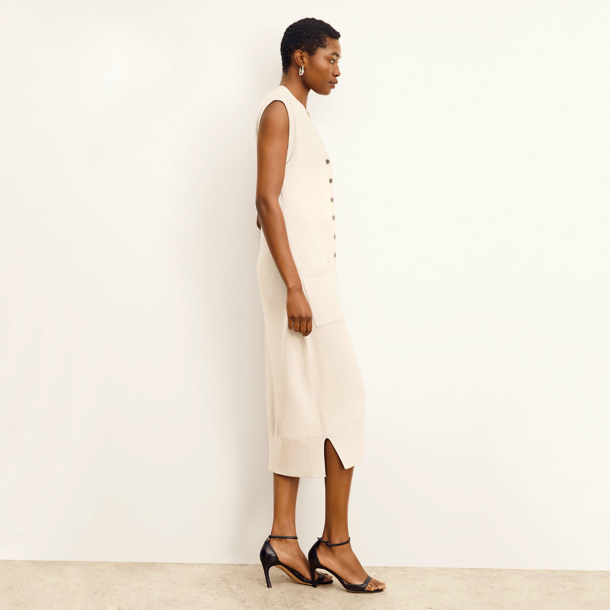 side image of a woman wearing the toula dress in ivory