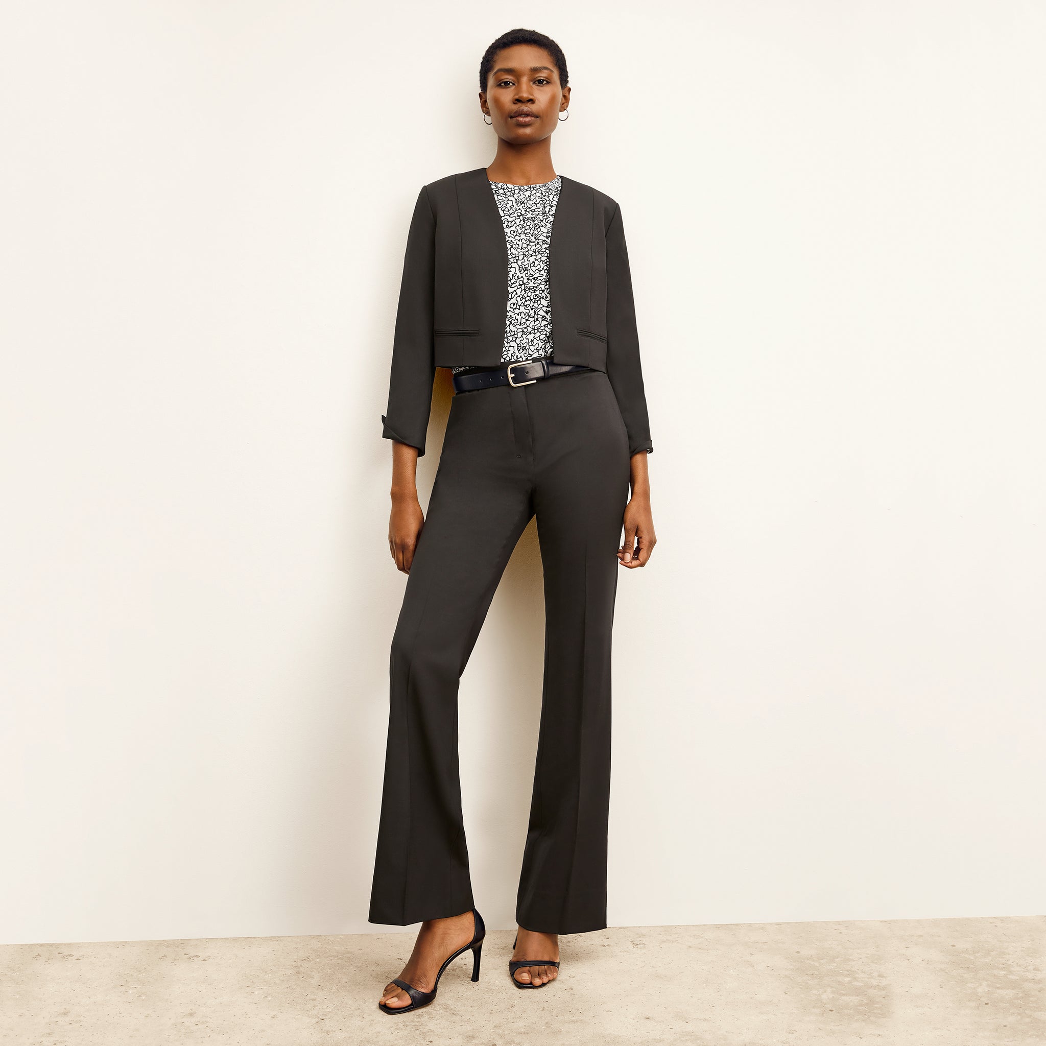 Front image of a woman standing wearing the Horton pant in black 