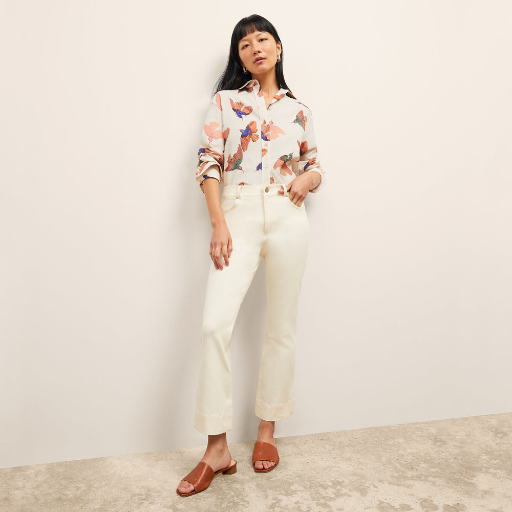 front image of a woman wearing the mila top in hummingbird print