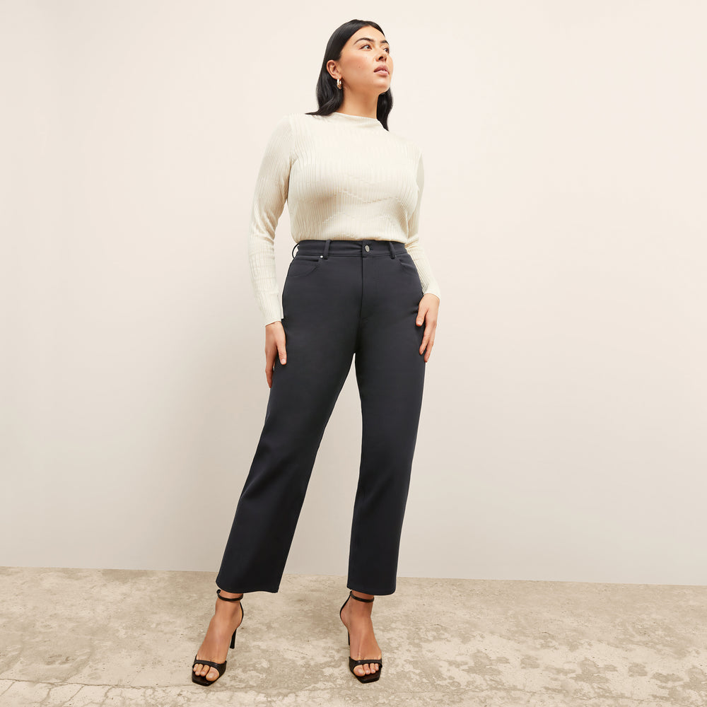 front image of a woman wearing the brodie top in ivory