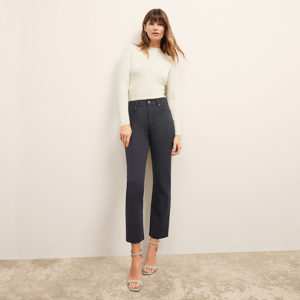 front image of a woman wearing the brodie top in ivory