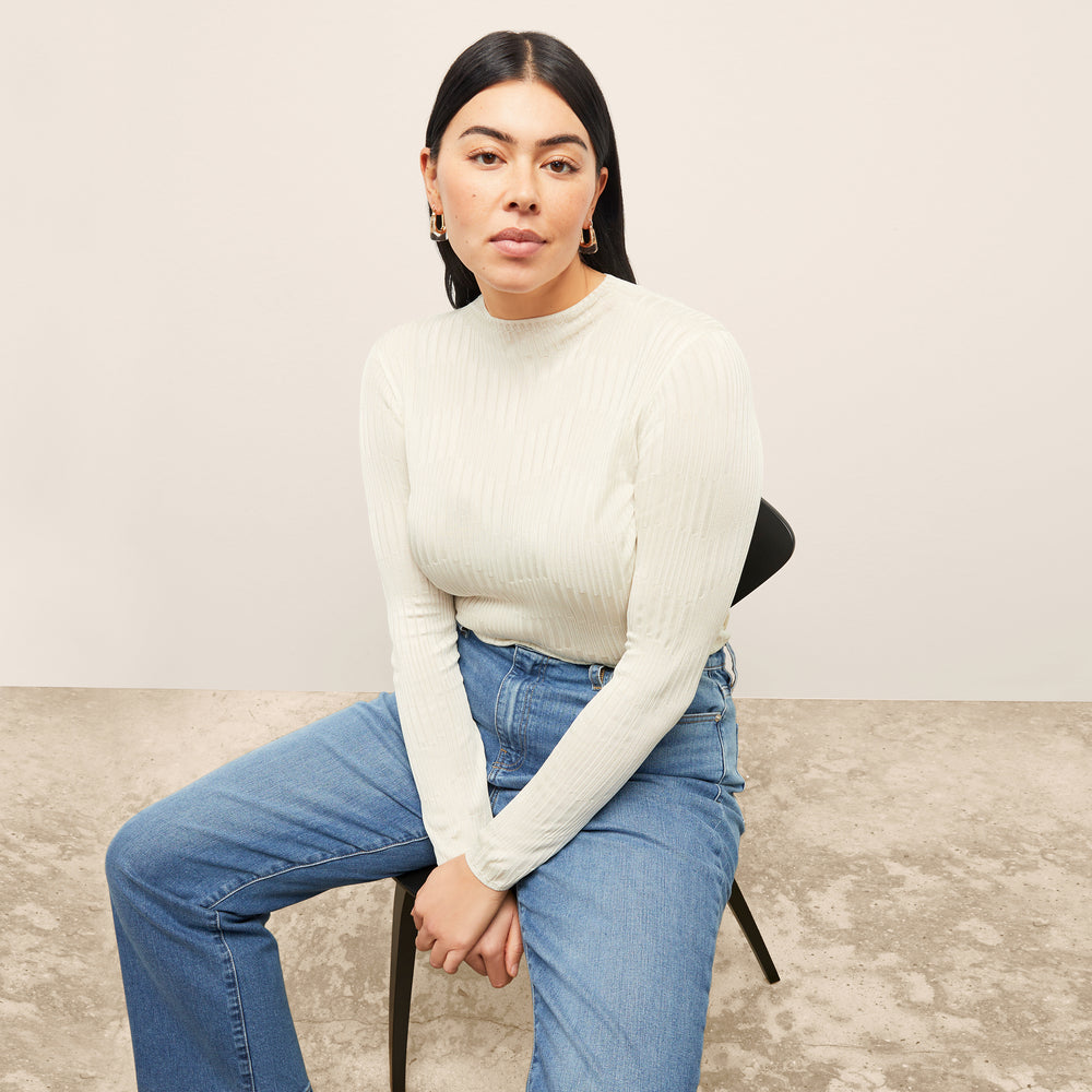 front image of a woman wearing the brodie top in ivory