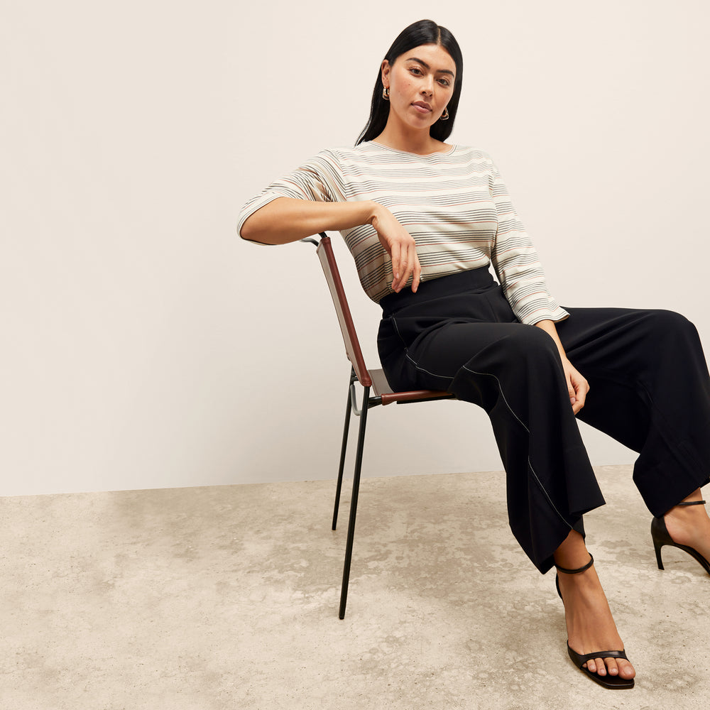 front image of a woman wearing the owen t-shirt in signature stripe