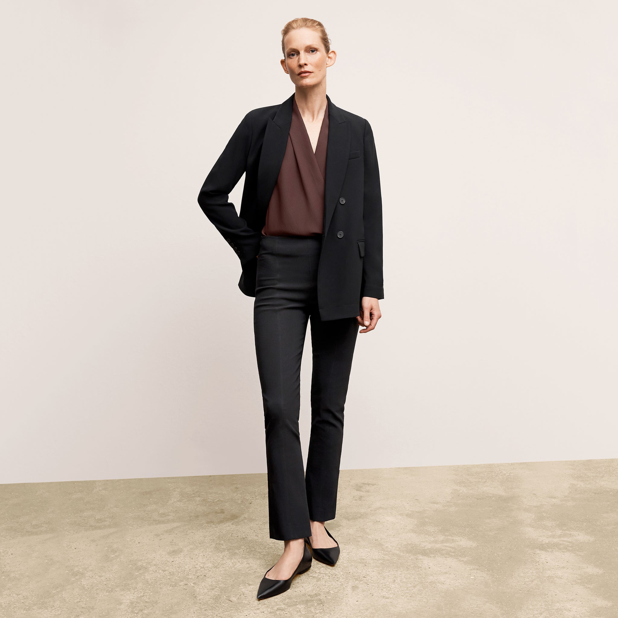 front image of a woman wearing the ohara jacket in black 