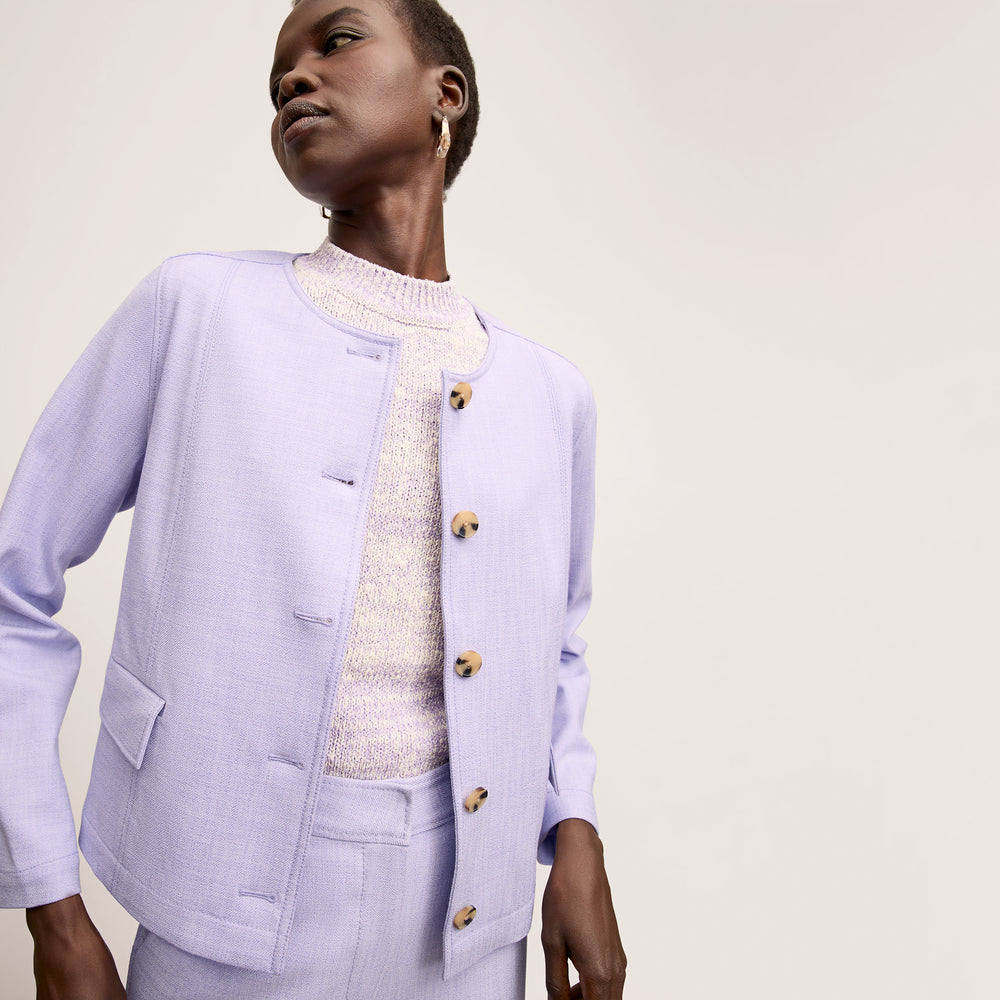 front image of a woman wearing the aniya jacket in lilac/ivory