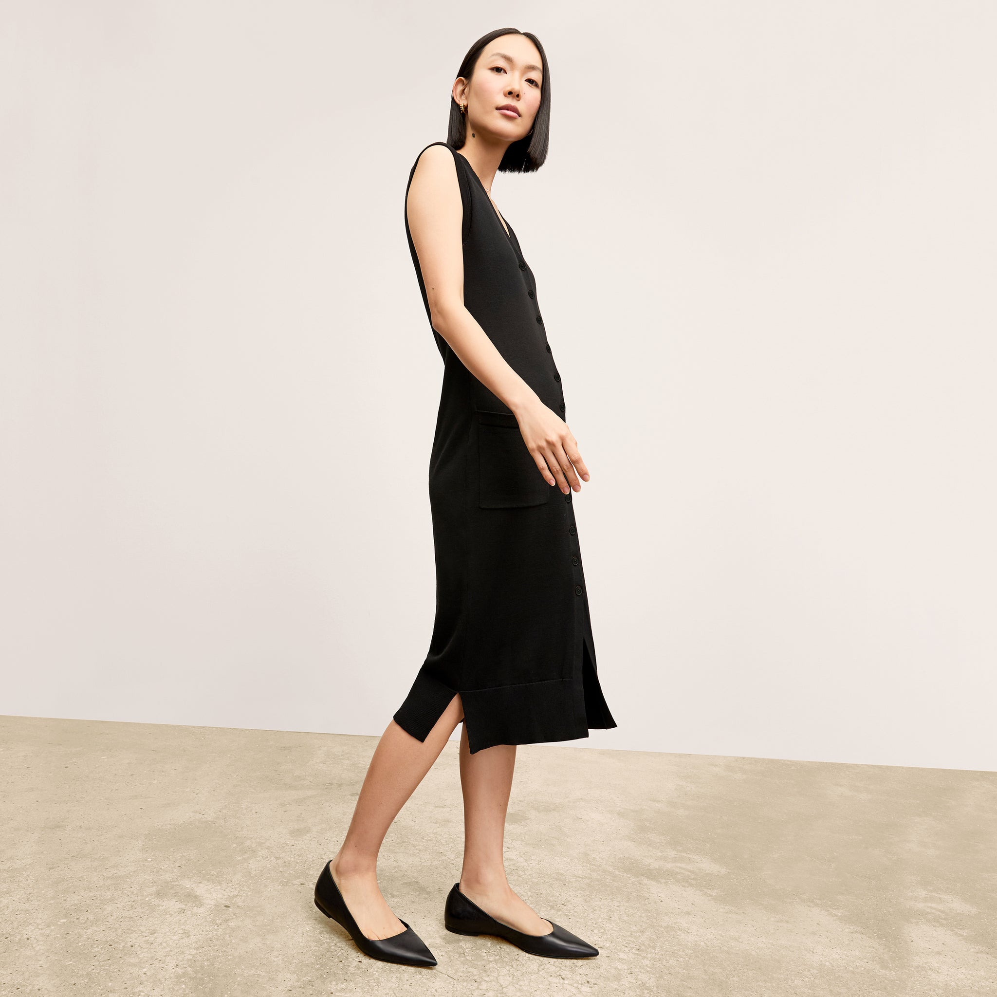 side image of a woman wearing the toula dress in black