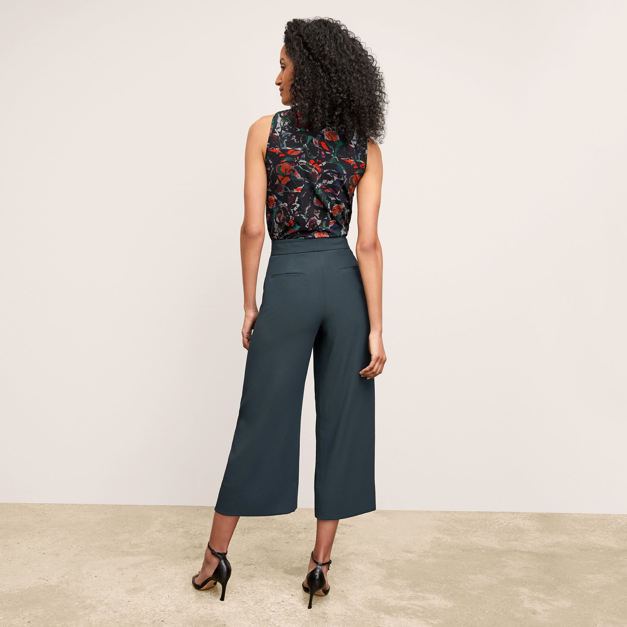 back image of a woman wearing the zhou pant in ocean