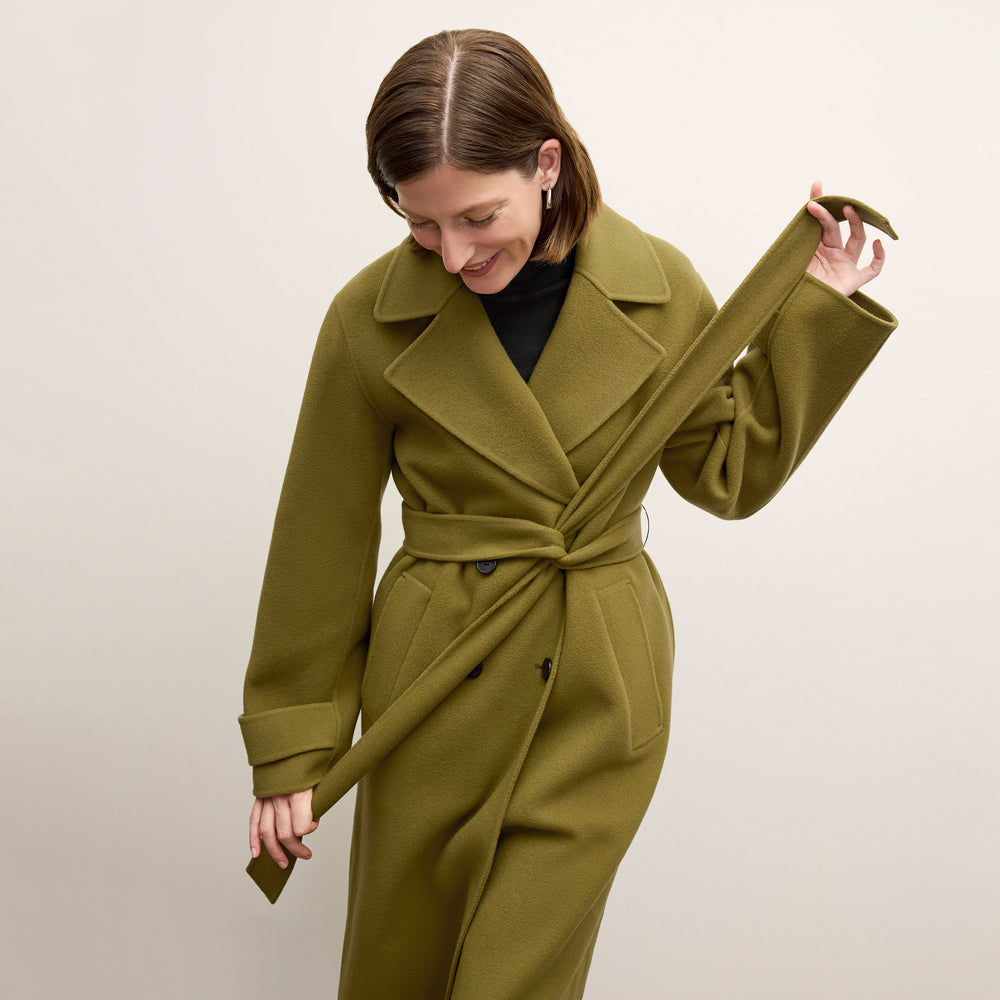 front image of a woman wearing the viola coat in pistachio