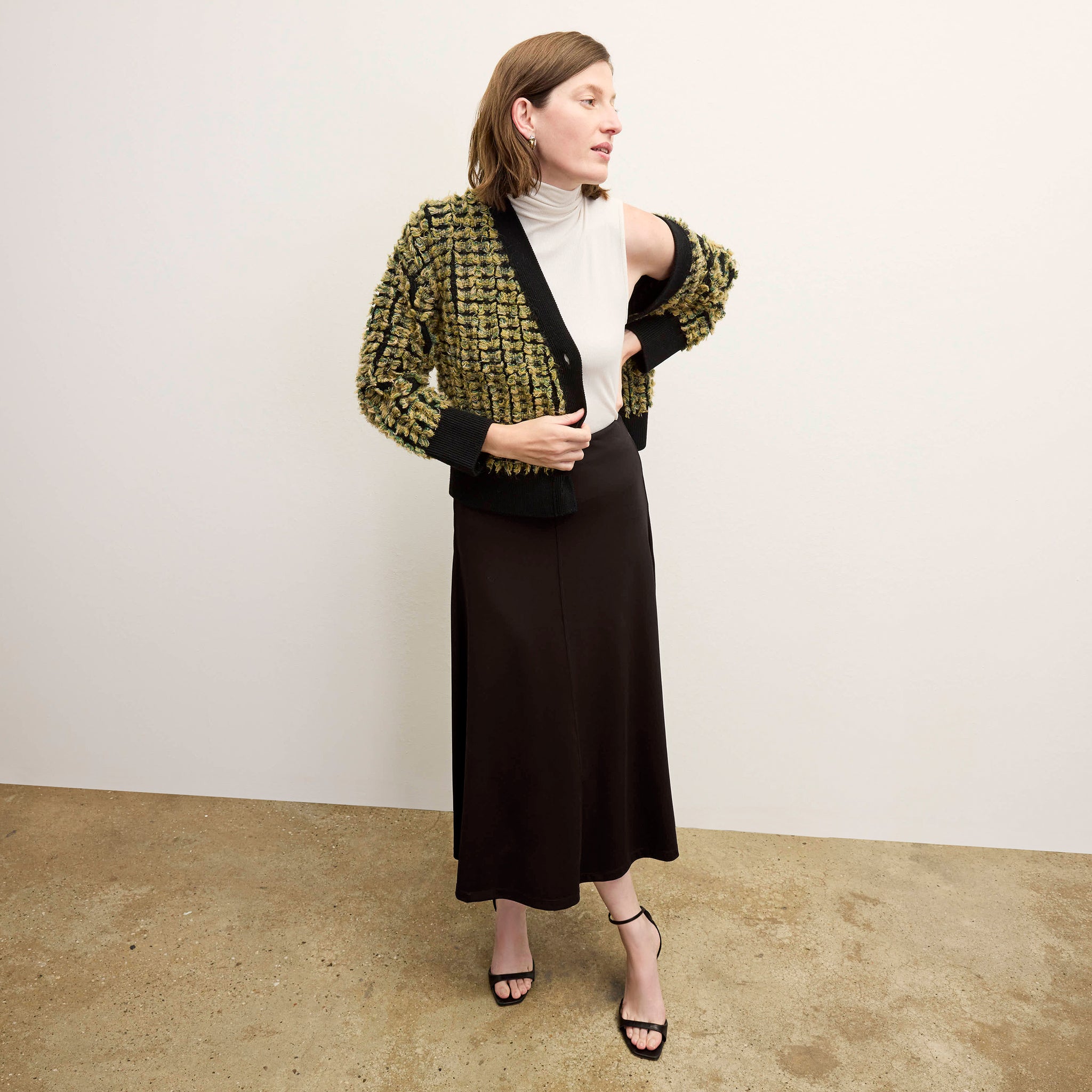front image of a woman wearing the misty skirt in black