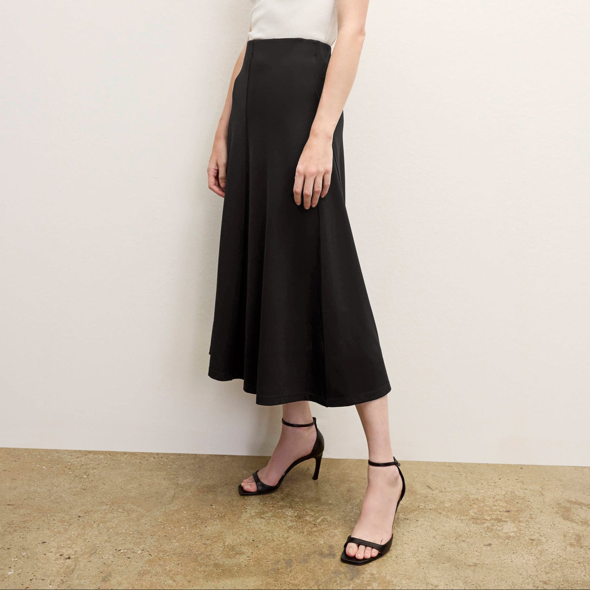 front image of a woman wearing the misty skirt in black 