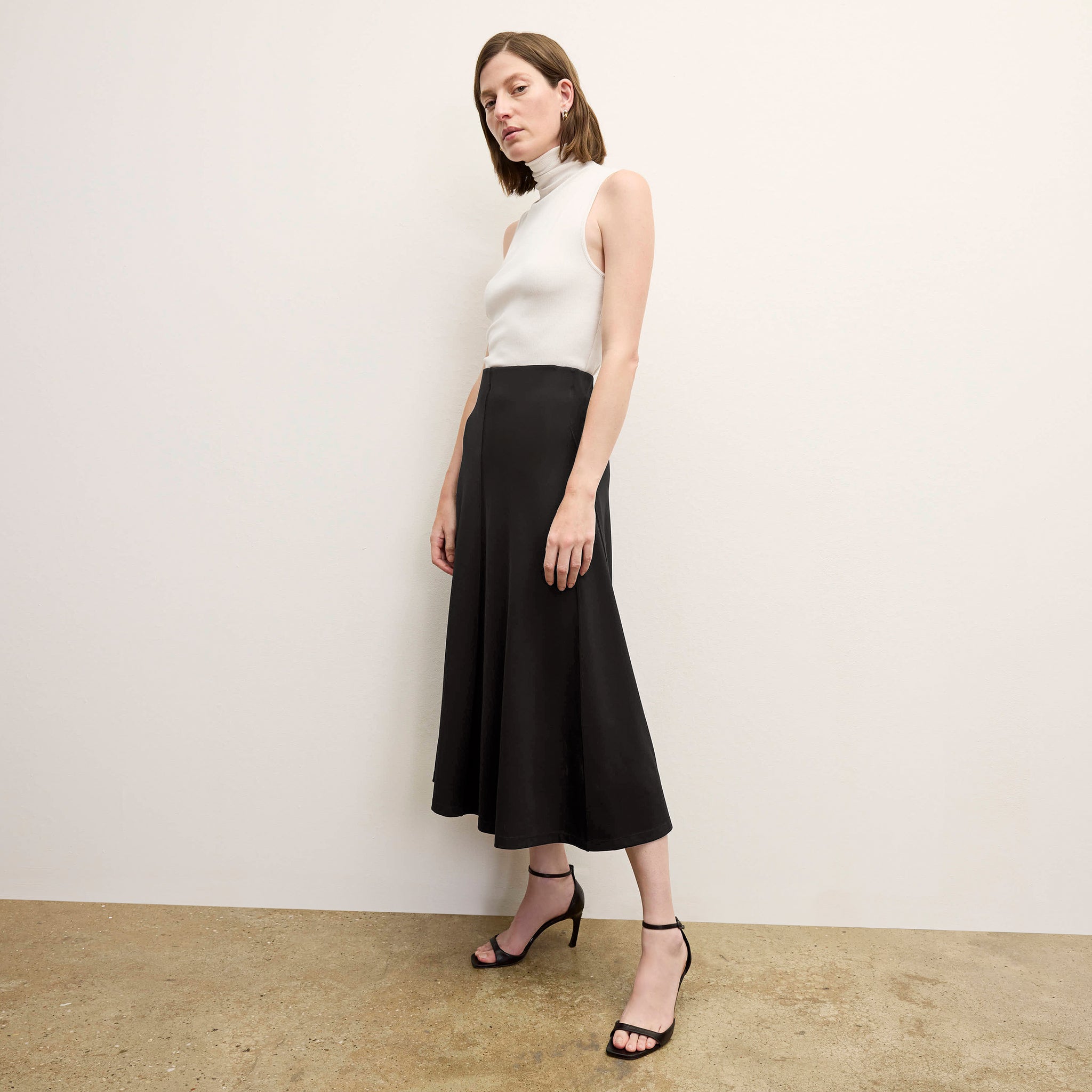 front image of a woman wearing the misty skirt in black