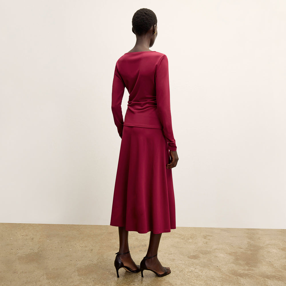back image of a woman wearing the misty skirt in grenache