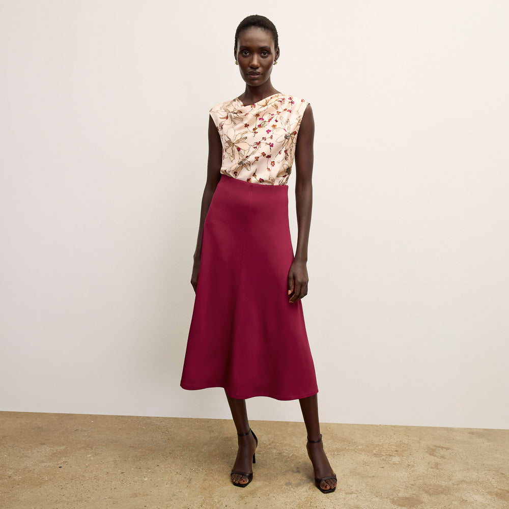 front image of a woman wearing the misty skirt in grenache