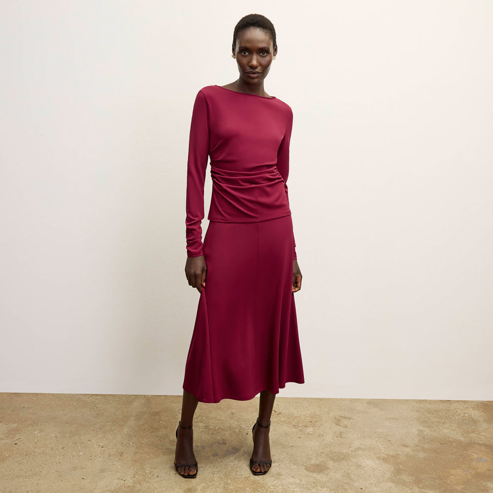 front image of a woman wearing the misty skirt in grenache
